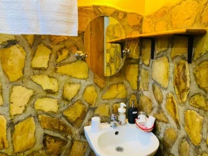 The stone-walled en-suite bathroom of the Mango Cottage.