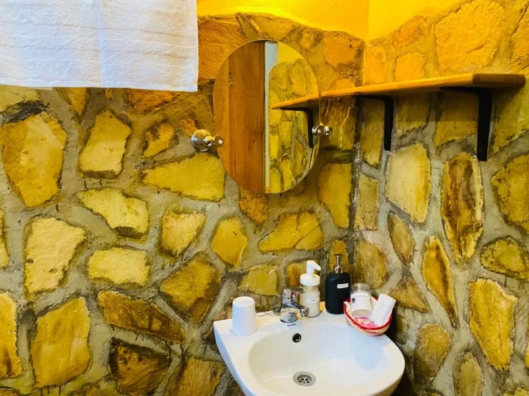 The stone-walled en-suite bathroom of the Mango Cottage.