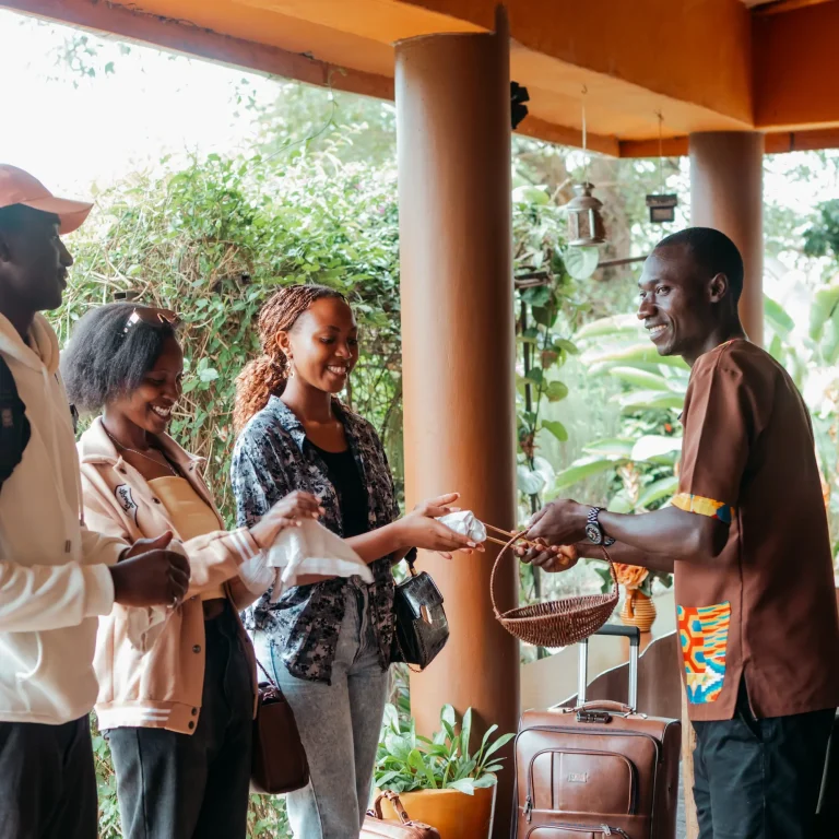 A guest receives a welcome drink at Nyore Hillside Retreat.