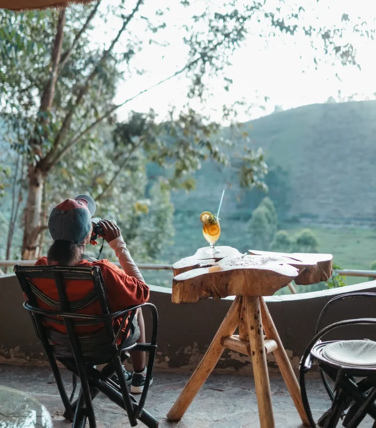 A guest relaxes on the terrace overlooking the surrounding hills.