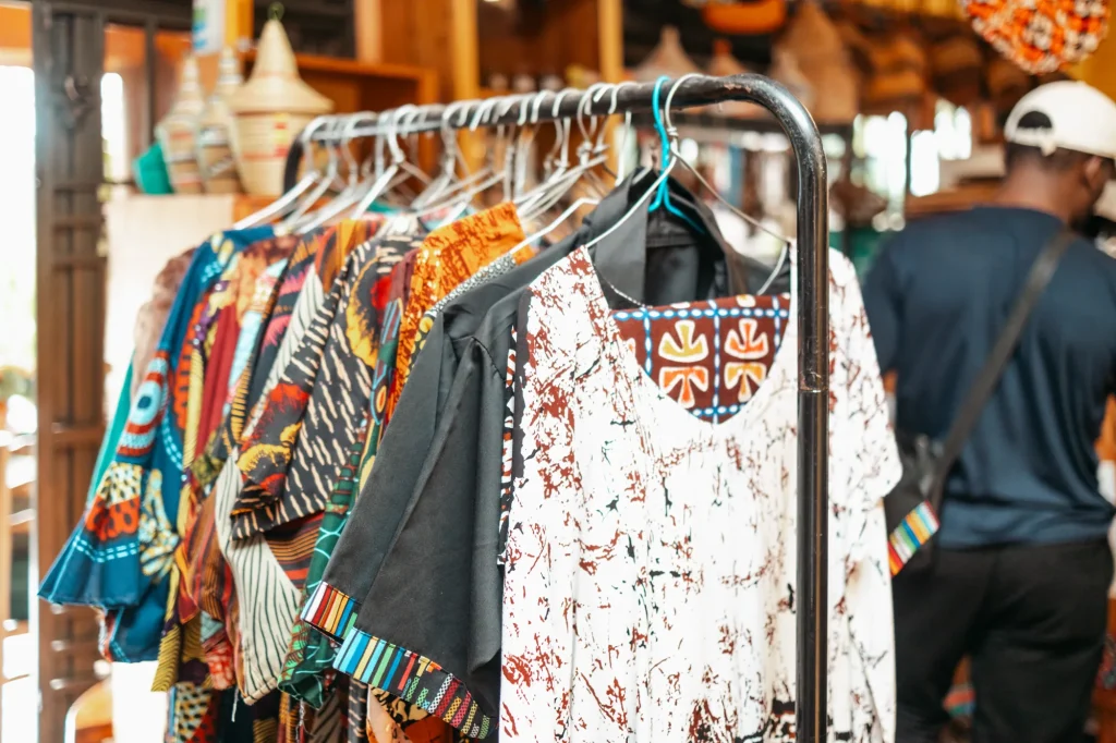 Colourful patterned clothing displayed in the craft shop.