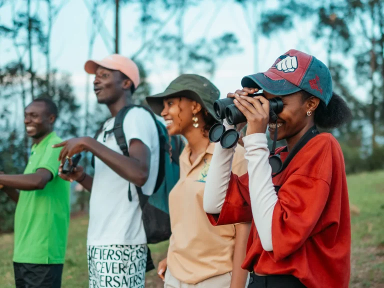 Guests use binoculars during a guided walk near Nyore.