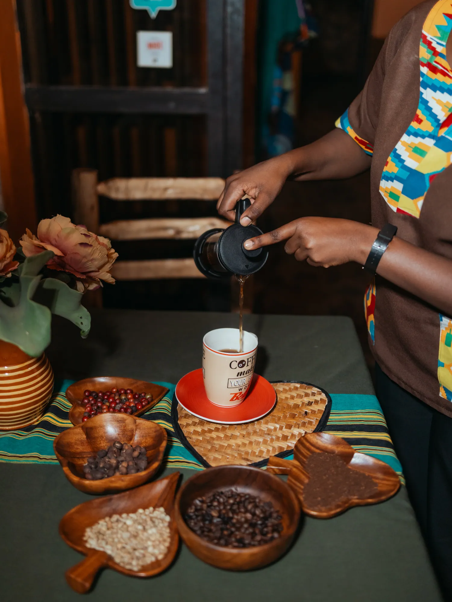 Homegrown coffee is poured beside bowls of roasted beans.