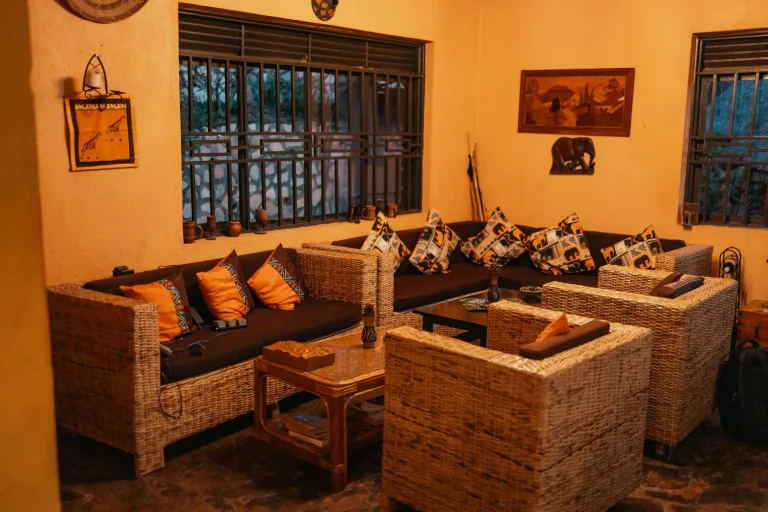Woven armchairs and patterned cushions in the warmly lit Nyore lounge.